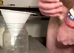 Suspended Jizz God Pumps a Jar Utter of His Seed