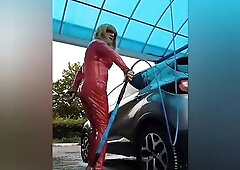 At the car washing station in red vinyl outfit
